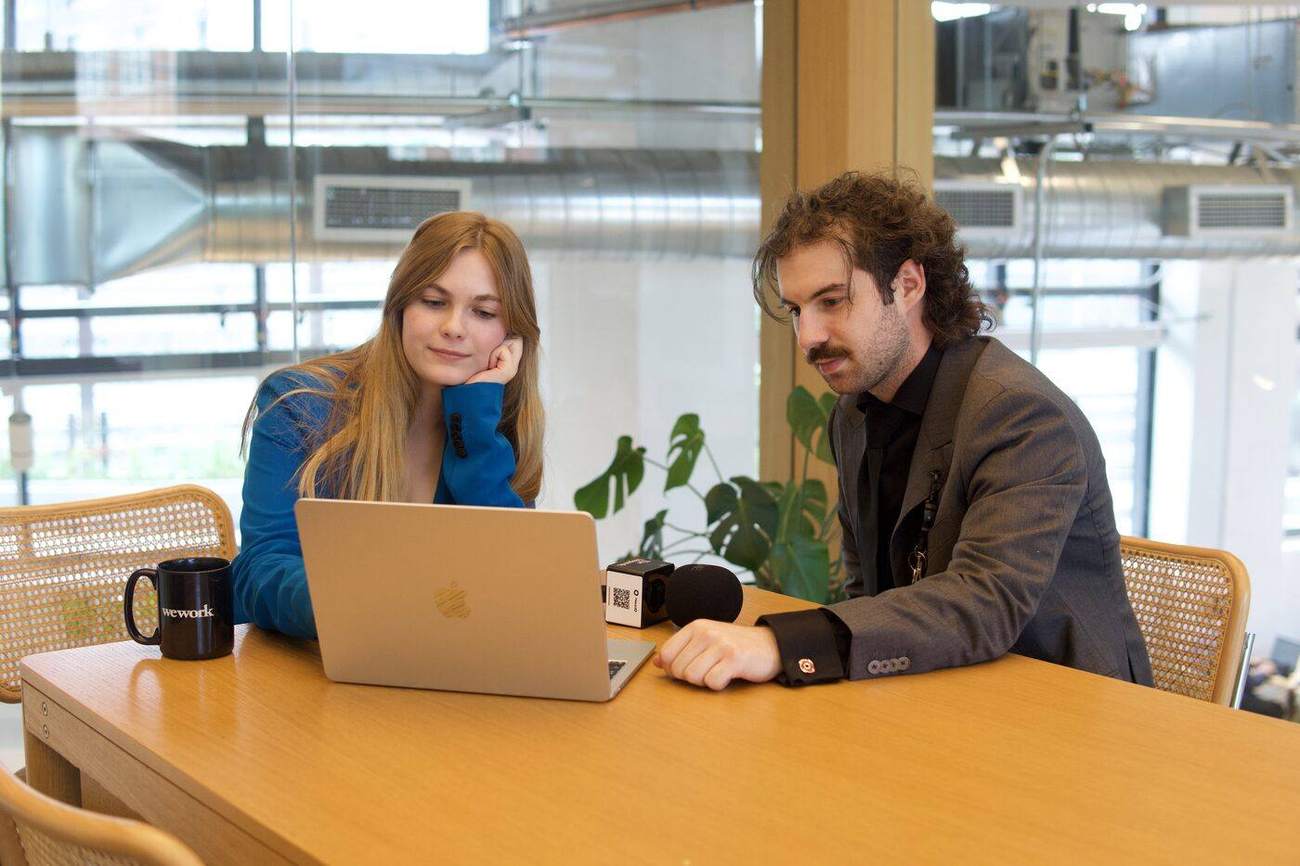 Ethan P. Daley and Grace Bashall working at a table with a laptop and a field recorder